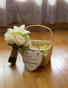 The flower girl had a basket and bouquet